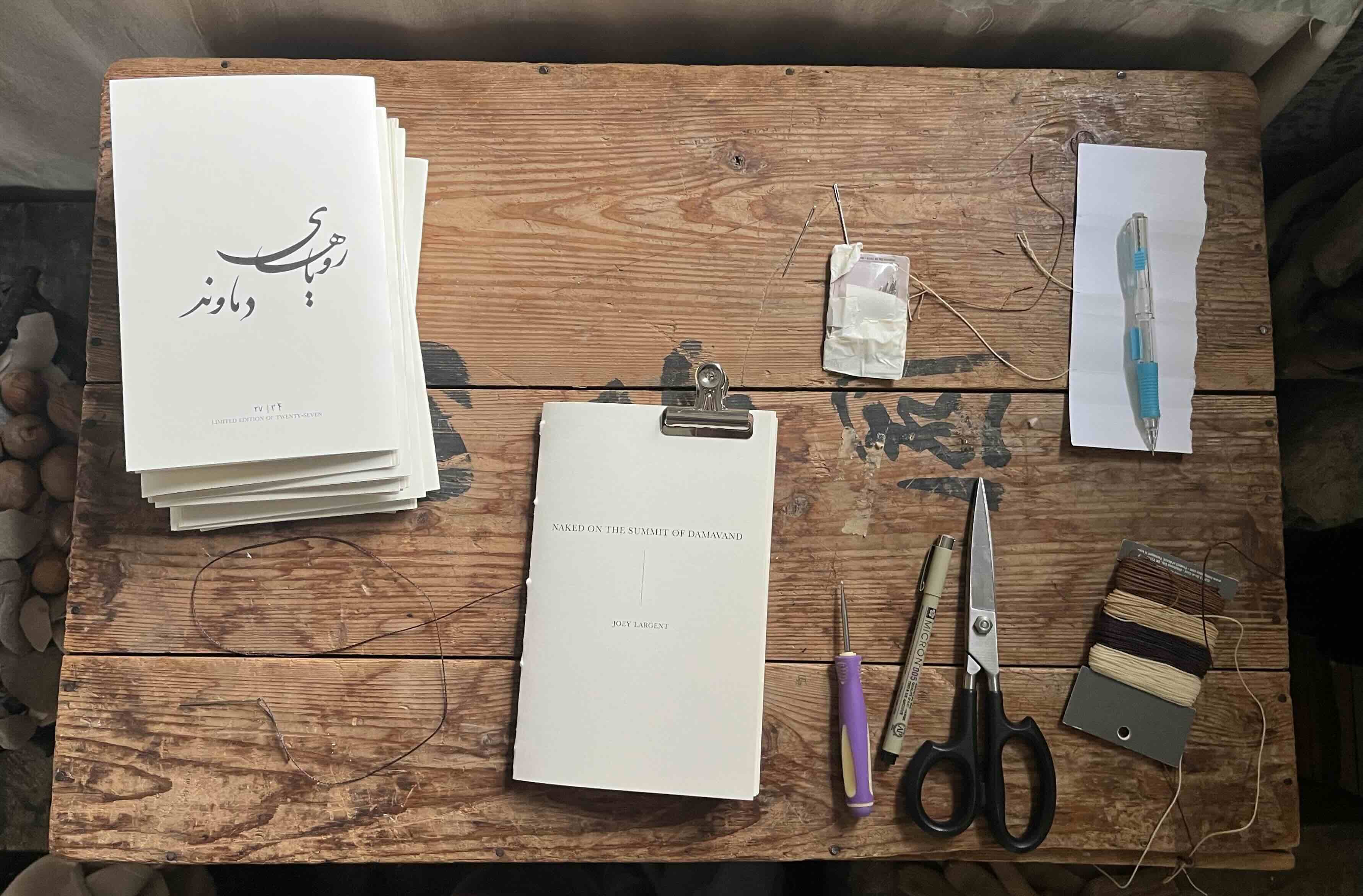 Hand-stitching the physical edition of the chapbook