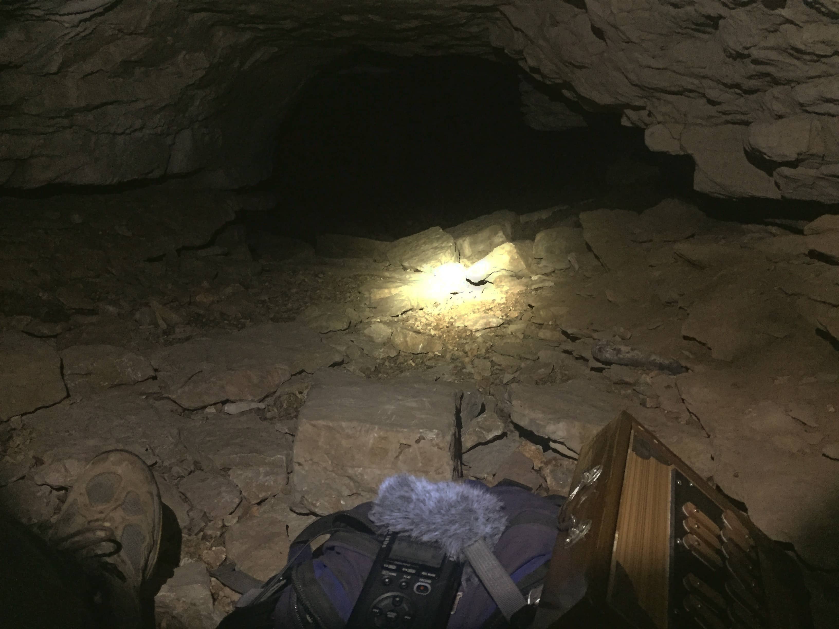 Shruti box and field recorder inside a small cave