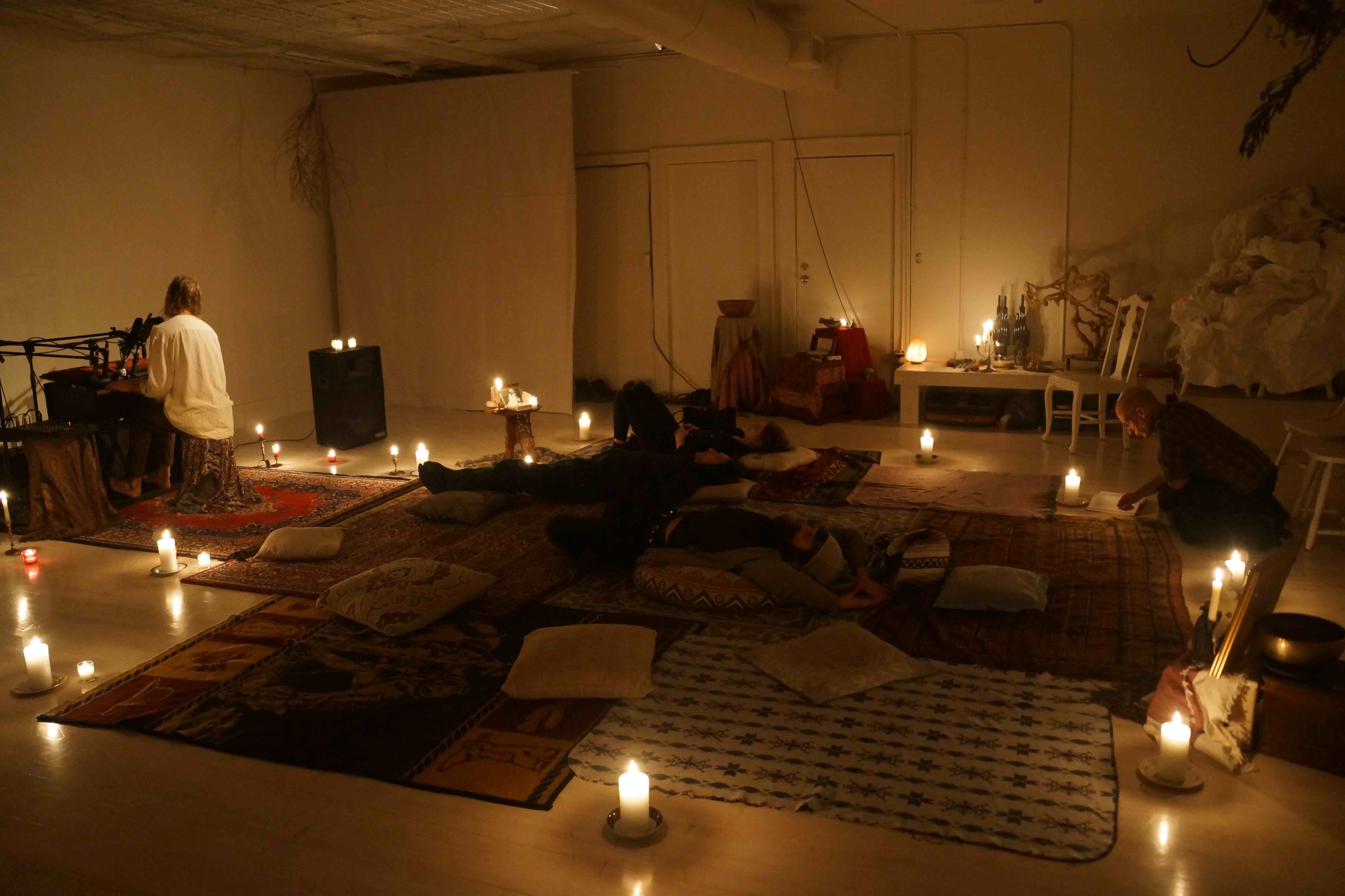 Audience resting on rugs during long-duration performance
